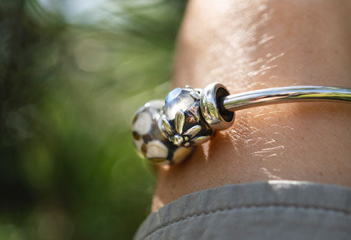 Mountain Edelweiss silver bead with faceted labradorite gemstone on silver bangle and silver spacers