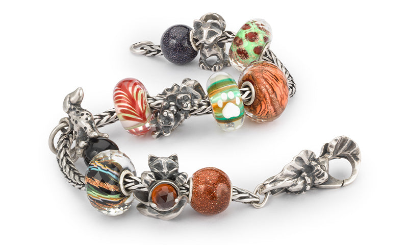 Silver bracelet with paw prints, symbolizing the love and connection between humans and animals.
