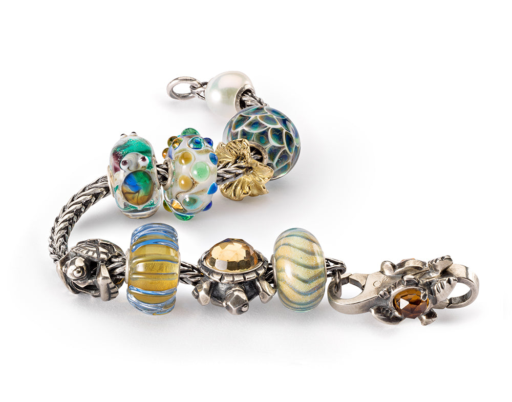 Trollbeads bracelet with turtle and ocean themed beads in glass and silver